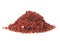 Heap of red pepper flakes isolated on white background. Pile crushed red pepper. Dried chili flakes
