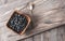 Heap ripe sweet blueberries and spoon on wooden table top view