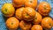 A heap of ripe tangerines on the kitchen towel
