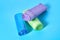 Heap of rolls of disposable plastic garbage bag on blue background