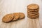 Heap of round brown biscuits on table