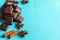 Heap of slices of chocolate, cinnamon sticks and stars anise on turquoise background.