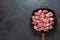 Heap small pieces raw meat in frying pan