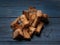 Heap of small rusks from black bread on a rustic wooden table