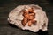 Heap of small rusks from black bread on a rustic wooden table