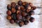 Heap of soap nuts on wooden background.