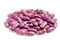 Heap of speckled purple kidney beans on white background