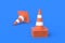 Heap of striped traffic cones, barriers on blue background