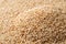 Heap of toasted sesame seeds macro texture. Pile of roasted Sesamum indicum background. White til as asian cuisine ingredient.