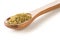 Heap of uncooked, raw freekeh or firik, roasted wheat grain, in wooden spoon over white