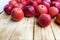 Heap of unwashed red apples mix on wooden background