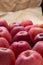 Heap of unwashed red apples mix on wooden background