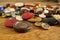 Heap of used worn colorful buttons on the wooden table