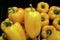 Heap of Vivid Yellow Fresh Ripe Bell Peppers with Green Stems