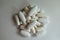 Heap of white magnesium citrate capsules, calcium citrate caplets and vitamin K tablets
