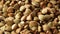 Heap of whole, raw, organic buckwheat grains rotating close up view