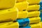 Heap of yellow and blue kayaks as abstract background