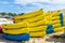 Heap of yellow and blue kayaks in Costa Brava, Spain