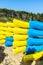 Heap of yellow and blue kayaks in Costa Brava, Spain