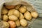 Heap Of Young Potatoes In Sackcloth Bag.