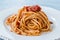 Heaped Plate of Classic Italian Pasta Spaghetti with Basil and Tomato Sauce