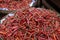 Heaps of dried chilies in baskets