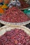 Heaps of dried chilies in a woven baskets