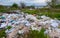 Heaps of plastic trash on the shore of the reservoir. Ecology of nature
