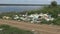 Heaps of plastic trash on the shore of the reservoir. Environmental pollution. Ecology of nature, unorganized garbage dump.