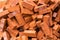 Heaps of red clay bricks at construction site