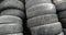 Heaps of used rubber car tires at processing recycling plant, camera in motion.