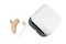 Hearing aid next to a white box on a white isolated background