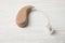 Hearing aid on white wooden table