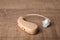 Hearing aid on wooden table, closeup.