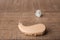 Hearing aid on wooden table, closeup.