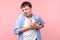 Heart attack. Portrait of sick brown-haired man clutching chest suffering acute pain. indoor studio shot isolated on pink