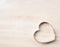 Heart biscuit cutter bake tool on white wooden background, top view