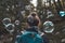 heart bubbles drifting around hikers head in forest