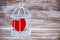 Heart in cage with wooden background