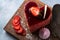 Heart Cake picture . Lovely delicious heart cake. A red colored cheesecake on a plate and a wooden table.