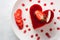 Heart Cake picture . Lovely delicious heart cake. A red colored cheesecake on a plate and a wooden table.