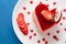 Heart Cake picture . Lovely delicious heart cake. A red colored cheesecake on a plate and a wooden table.