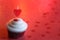 Heart candle in the cupcake on the love abstract defocused valentines day red background