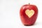 Heart carved into red apple