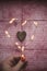 Heart from Christmas lights on rustic background