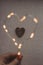 Heart from Christmas lights on rustic background