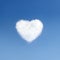 Heart of clouds symbol of love on background of blue sky