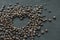 Heart of coffee beans on white background