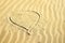 Heart contour on yellow sand. Mother`s Day, Valentine`s Day background.