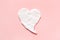 Heart from cream in pink background. Smear of natural moisturizer. Lotion for face or body